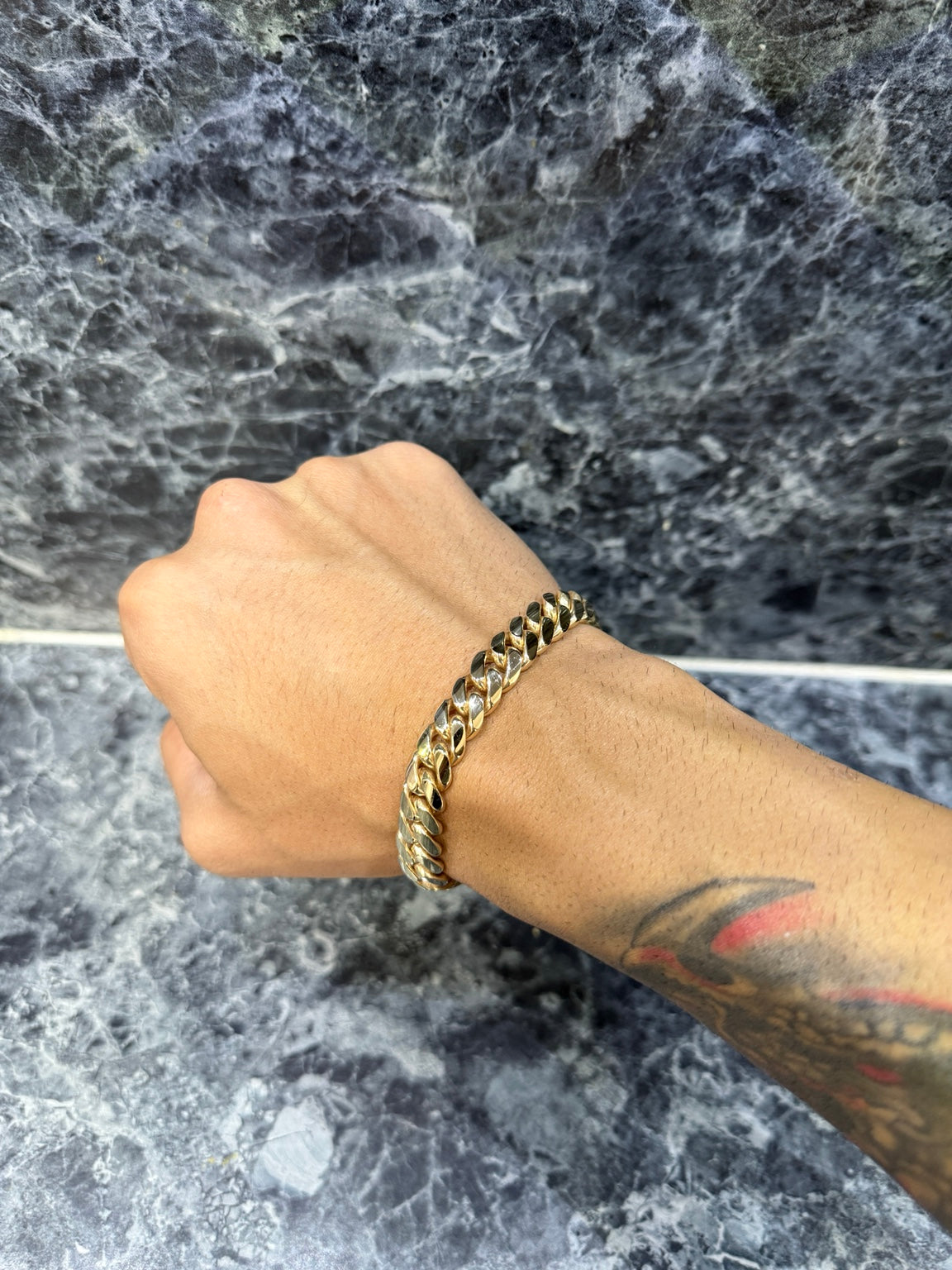 10mm Heavy 14K Gold Bonded Miami Cuban link bracelet worn on wrist
